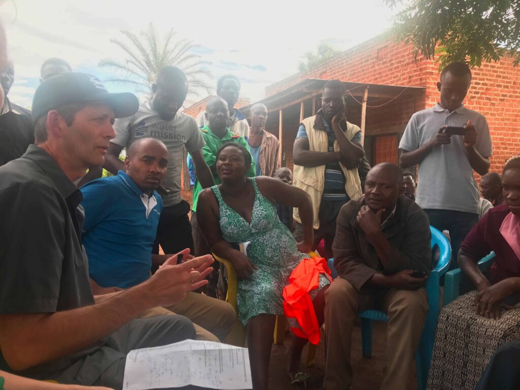 Jack talks to the families in Buwikwe, Uganda, about the film story on their village.